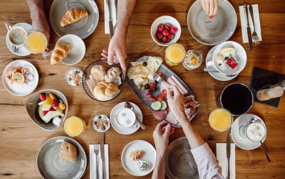 Reich gedeckter Fr&uuml;hst&uuml;ckstisch mit Obst, Geb&auml;ck und S&auml;ften im Hotel Resl
